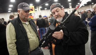 
              Gun owners discuss a potential sale of an AR-15, one of the most popular and controversial weapons, during the 2013 Rocky Mountain Gun Show at the South Towne Expo Center in Sandy, Utah